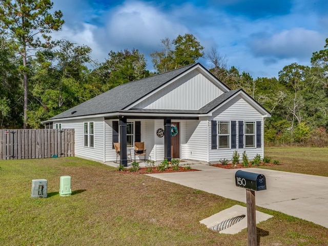 view of front of house with covered porch and a front yard