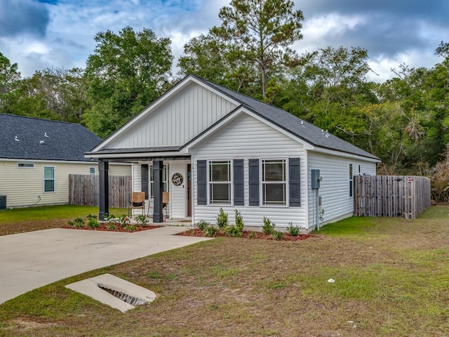 view of front of house featuring a front yard and central AC