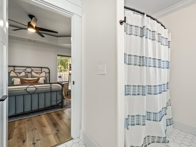 bathroom featuring ceiling fan and ornamental molding