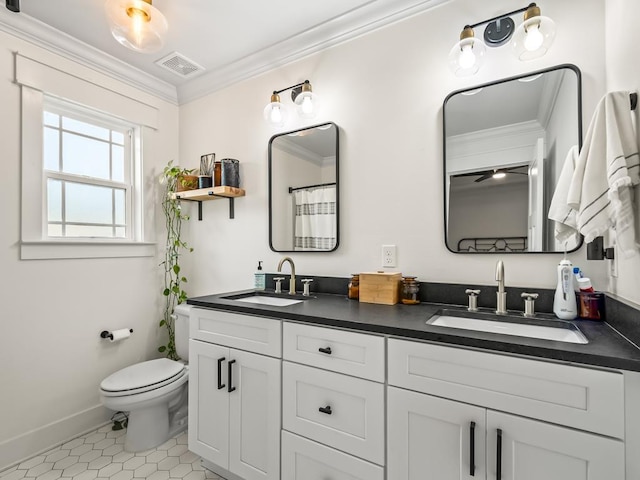 bathroom with tile patterned flooring, vanity, toilet, and crown molding