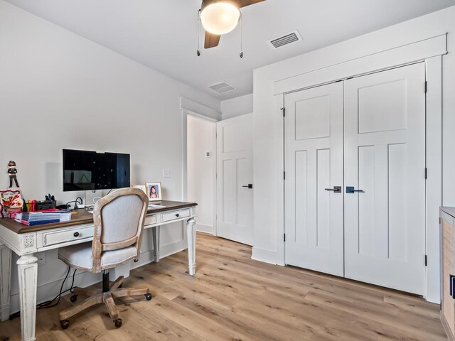 home office with ceiling fan and light hardwood / wood-style flooring