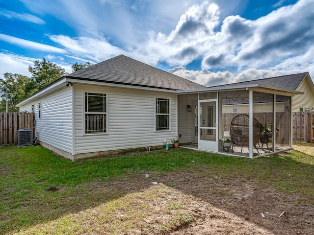 back of house with a lawn, central air condition unit, a sunroom, and a patio