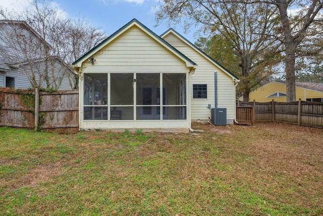 back of house featuring cooling unit, a lawn, a fenced backyard, and a sunroom