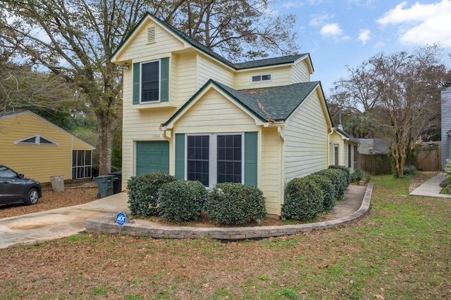 view of front of home with fence, a garage, driveway, and a shingled roof