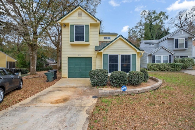 traditional home featuring concrete driveway and an attached garage