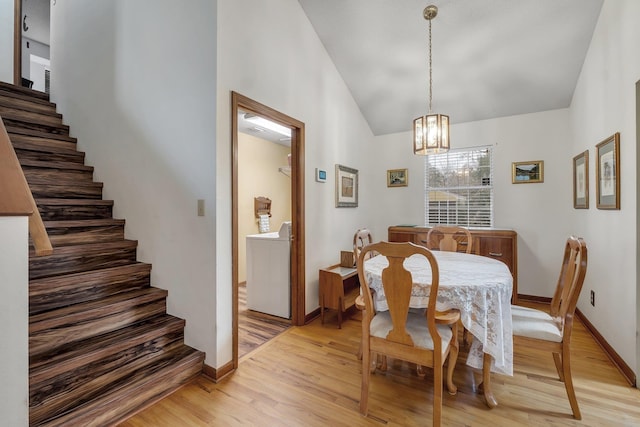 dining area with stairway, light wood-style flooring, washer / clothes dryer, and baseboards