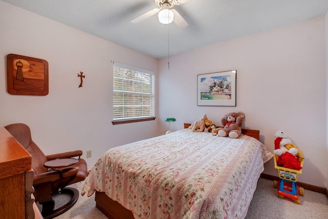 carpeted bedroom featuring ceiling fan and baseboards