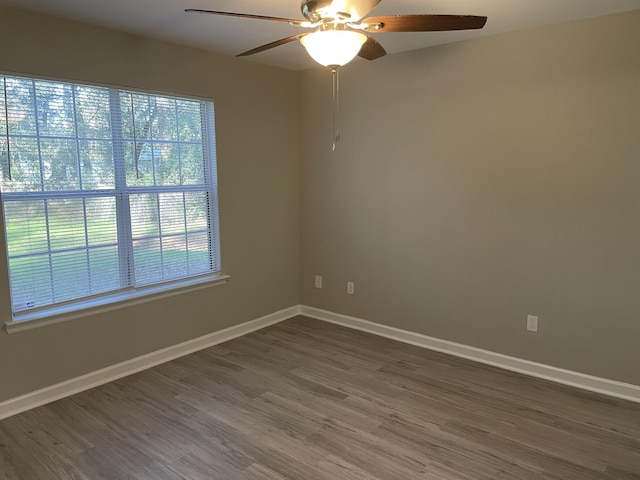 spare room featuring ceiling fan and dark hardwood / wood-style flooring