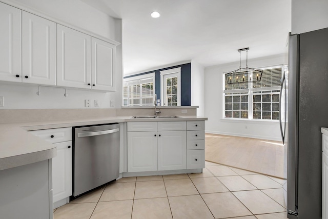 kitchen featuring decorative light fixtures, stainless steel appliances, a healthy amount of sunlight, and sink