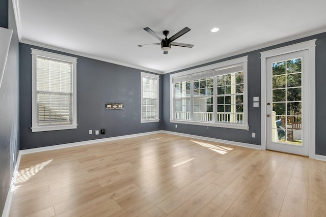 empty room with ceiling fan, light hardwood / wood-style flooring, and ornamental molding