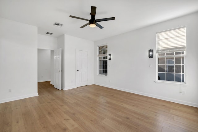 empty room with light hardwood / wood-style flooring and ceiling fan