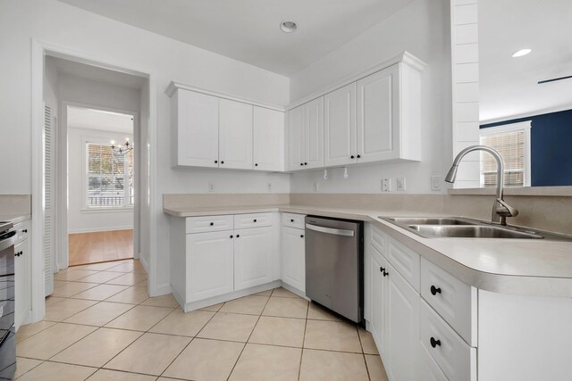 kitchen with white cabinets, sink, a notable chandelier, dishwasher, and light tile patterned flooring