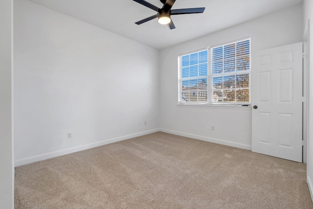 unfurnished room featuring ceiling fan and light carpet