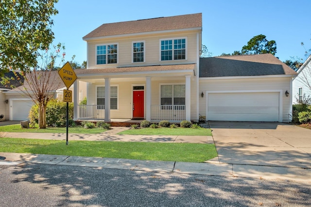 view of front of property featuring covered porch and a garage