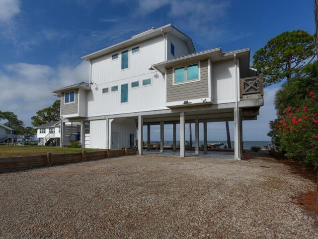 back of house featuring a carport