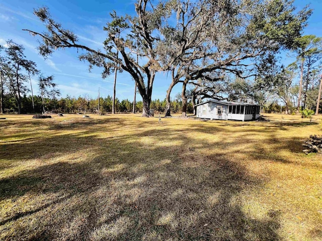 view of yard with a sunroom