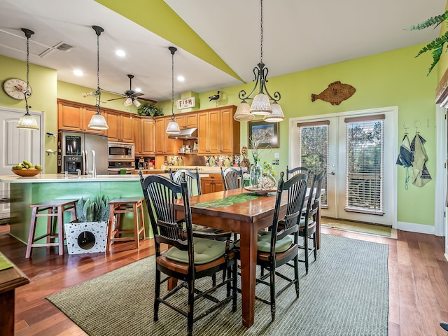 dining space featuring wood-type flooring, ceiling fan, and french doors