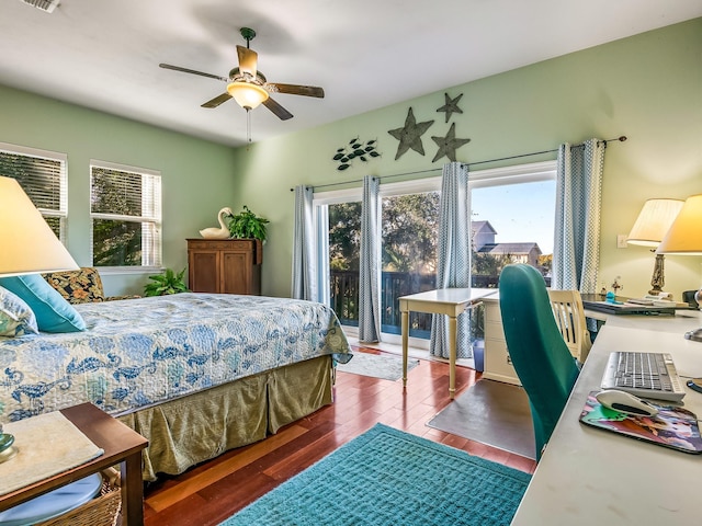 bedroom featuring dark wood-type flooring, ceiling fan, and multiple windows