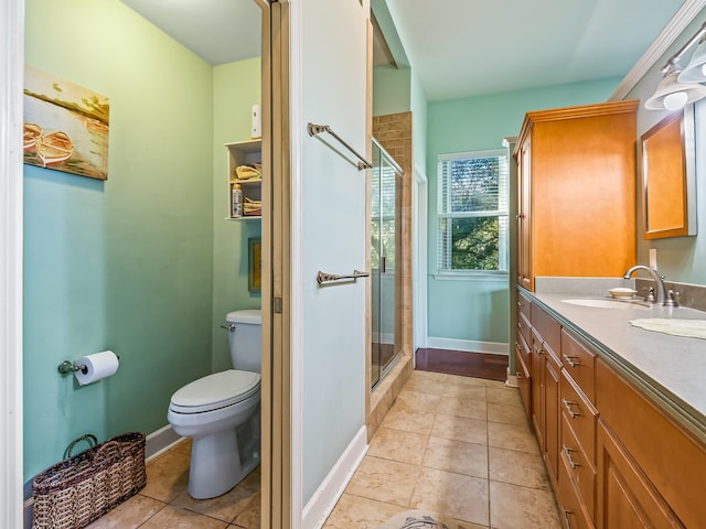 bathroom with vanity, a shower with shower door, tile patterned floors, and toilet