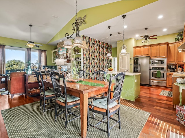 dining space with ceiling fan, dark hardwood / wood-style floors, and vaulted ceiling