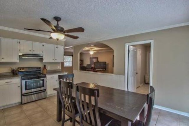 kitchen with ceiling fan, white cabinetry, a textured ceiling, and stainless steel range with electric cooktop