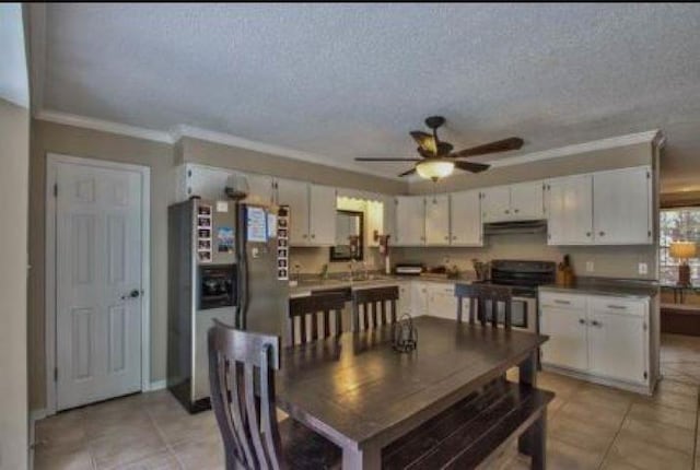 dining room featuring ceiling fan, a textured ceiling, light tile patterned floors, and crown molding