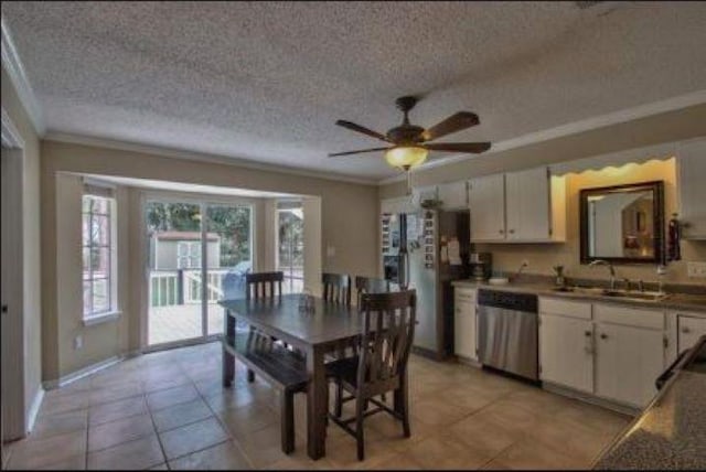 kitchen with ceiling fan, appliances with stainless steel finishes, sink, white cabinets, and ornamental molding