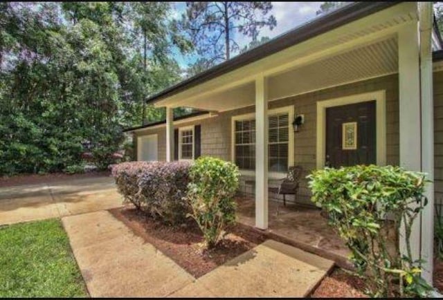 doorway to property with a porch