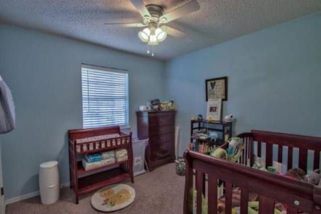 bedroom with ceiling fan, a textured ceiling, and carpet flooring