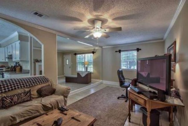 tiled home office with a textured ceiling, ceiling fan, and ornamental molding