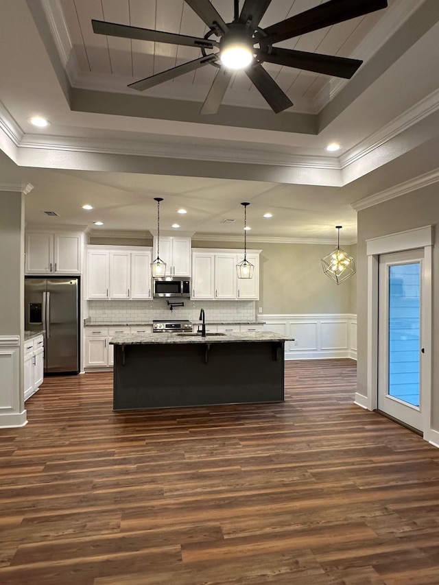 2725 Masterson Ln, Tallahassee, FL 32311 - kitchen with a decorative wall, a kitchen bar, stainless steel appliances, and a raised ceiling