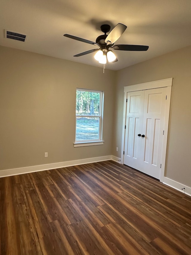2725 Masterson Ln, Tallahassee, FL 32311 - unfurnished bedroom with dark wood-style floors, ceiling fan, visible vents, and baseboards