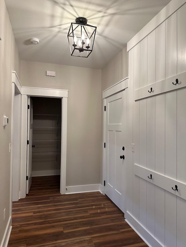 2725 Masterson Ln, Tallahassee, FL 32311 - corridor with dark wood finished floors, baseboards, and an inviting chandelier