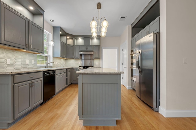 332 Winnstead Ct, Tallahassee, FL 32312 - kitchen with stainless steel fridge, dishwasher, gray cabinets, under cabinet range hood, and a kitchen island