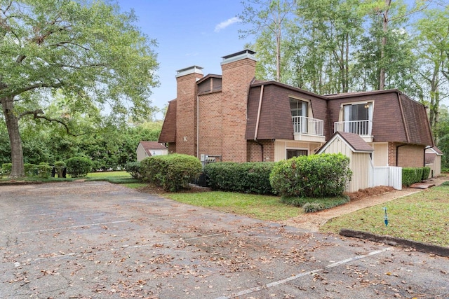 view of side of property with a balcony