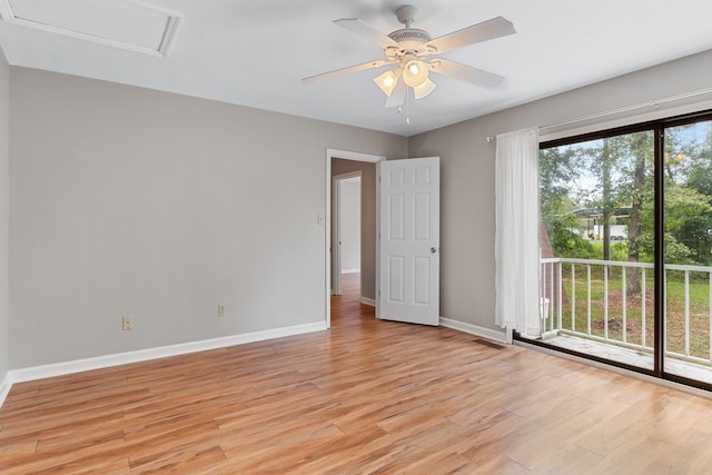 empty room with ceiling fan and light hardwood / wood-style floors