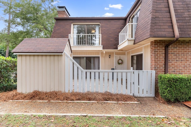 view of front of house featuring a balcony