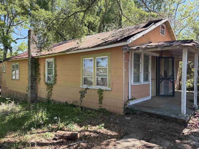 810 Taylor St Unit 1 & 2, Tallahassee, FL 32310 - view of side of property with metal roof and a chimney