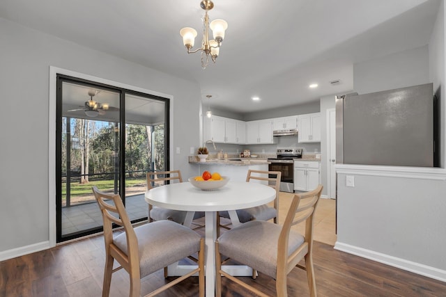 dining area featuring recessed lighting, wood finished floors, visible vents, baseboards, and an inviting chandelier