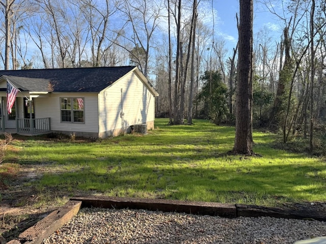 view of side of home with a lawn