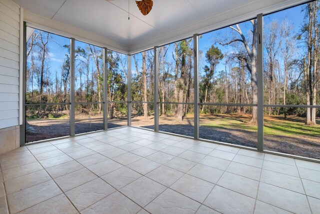 unfurnished sunroom with ceiling fan