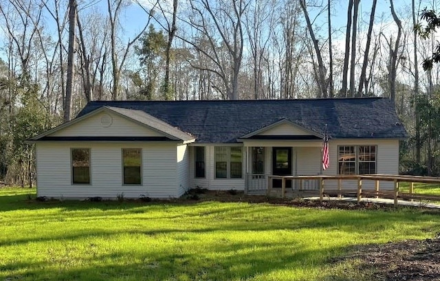 view of front of house with covered porch and a front lawn