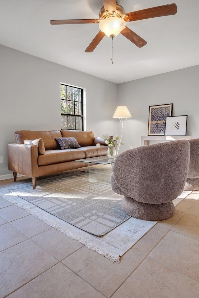 living room with ceiling fan and light tile patterned floors