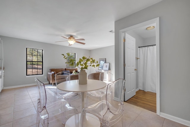 dining area with visible vents, ceiling fan, baseboards, and light tile patterned floors