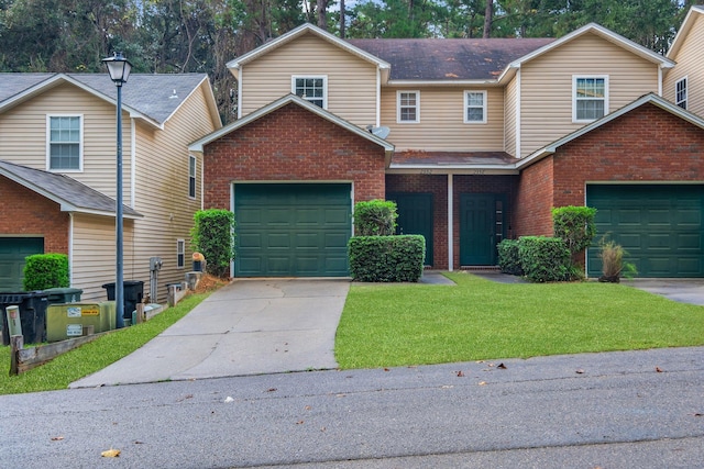 view of front facade with a garage, concrete driveway, brick siding, and a front yard