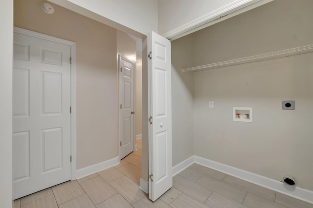 clothes washing area featuring wood finish floors, hookup for a washing machine, hookup for an electric dryer, laundry area, and baseboards