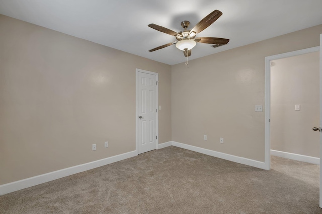 unfurnished room featuring light carpet, ceiling fan, and baseboards