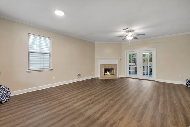 unfurnished living room featuring baseboards, visible vents, crown molding, and french doors