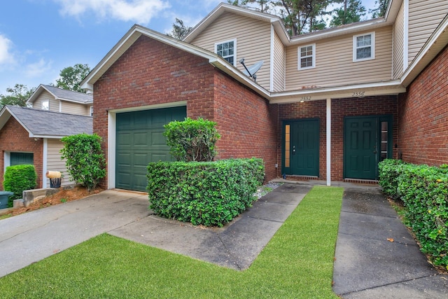 view of front of home with brick siding and an attached garage