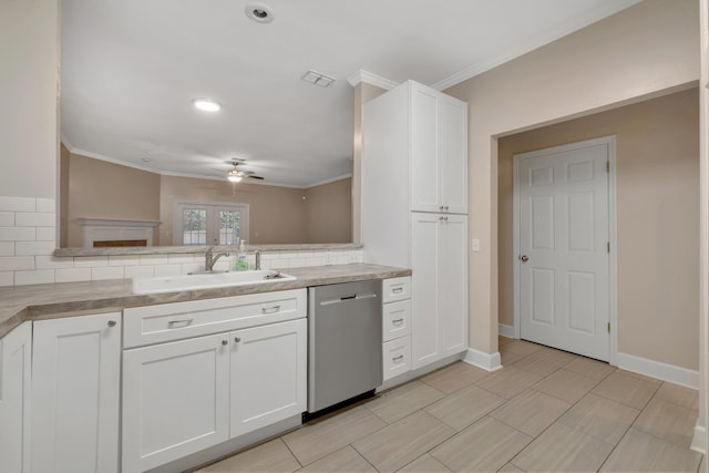 kitchen featuring a sink, white cabinetry, backsplash, and stainless steel dishwasher